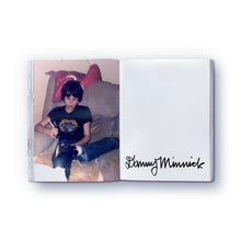 Load image into Gallery viewer, A photo of artist on a page of a paperback book titled 'The elephant never forgets' by Danny Minnick.