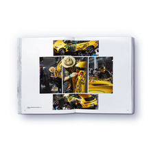 Load image into Gallery viewer, A colorful, abstract artwork on a yellow car page of a paperback book titled 'The elephant never forgets' by Danny Minnick.